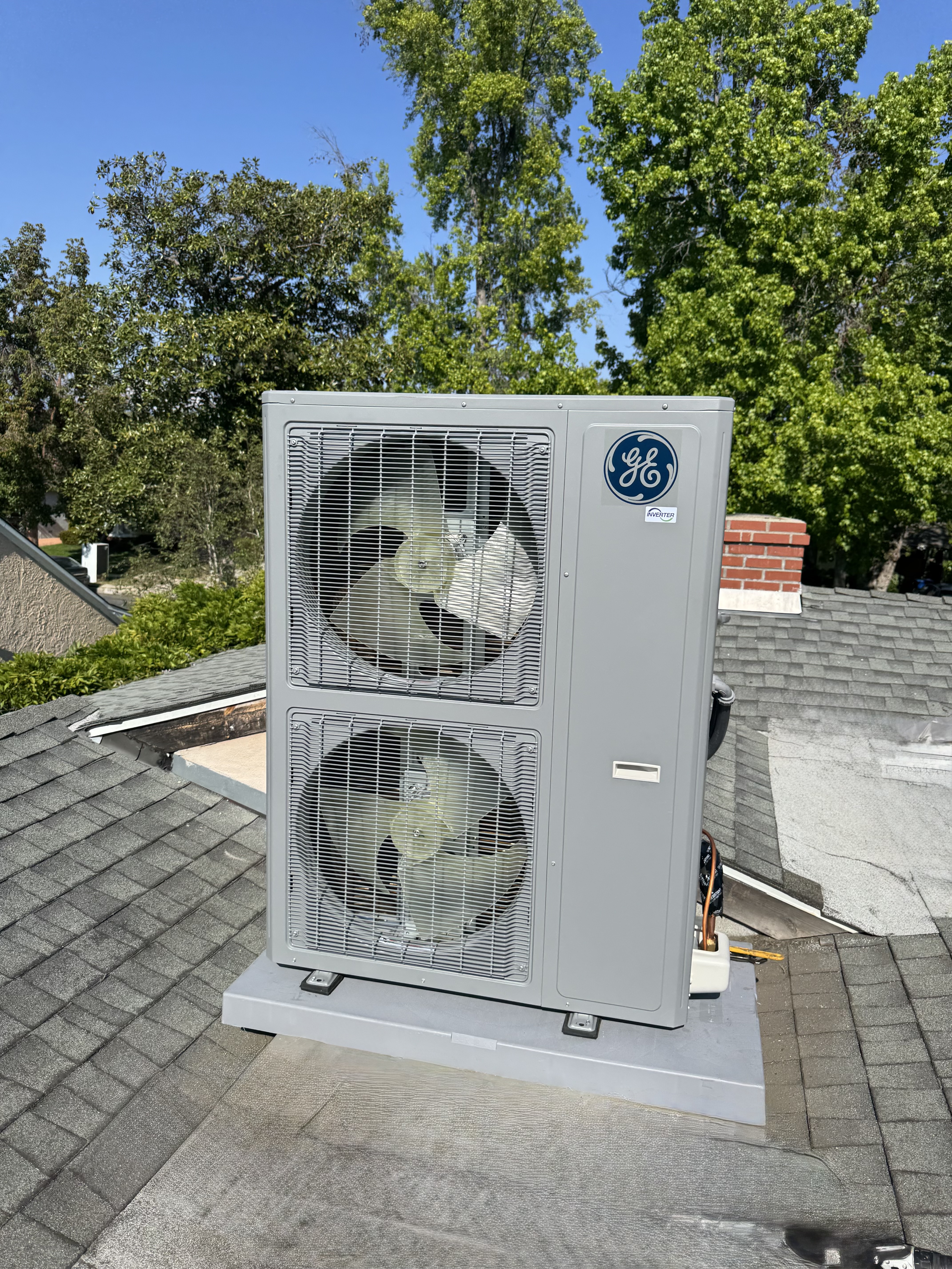 Rooftop heat pump and dual-fan HVAC unit installed on a California home